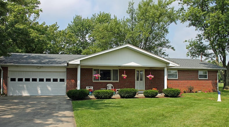 Situated on a wooded lot, this home offers about 1,860 sq. ft. of living space with 3 bedrooms and a covered front porch. CONTRIBUTED PHOTO BY VICKIE KAPNAS