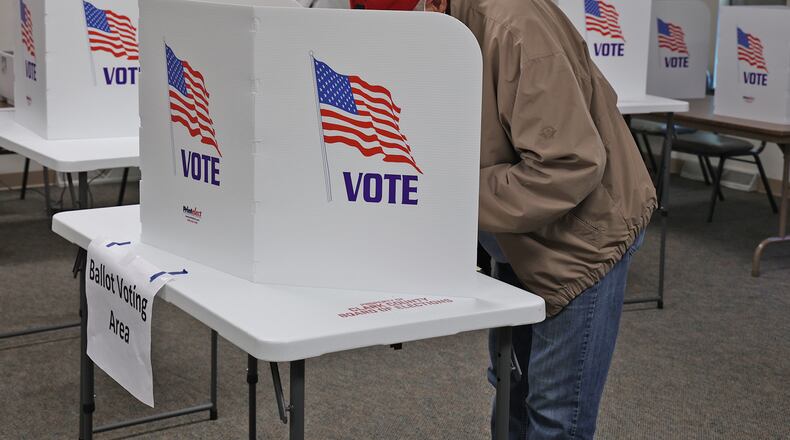 A voter casts his vote at the Covenant United Methodist Church in Springfield Tuesday. BILL LACKEY/STAFF
