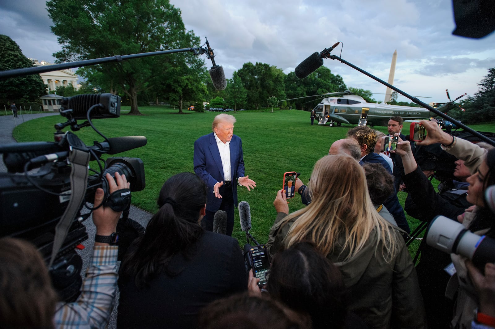 President Donald Trump speaks with reporters after disembarking Marine One upon arrival on the South Lawn of the White House in Washington, Sunday, May 4, 2025. (AP Photo/Rod Lamkey, Jr.)
