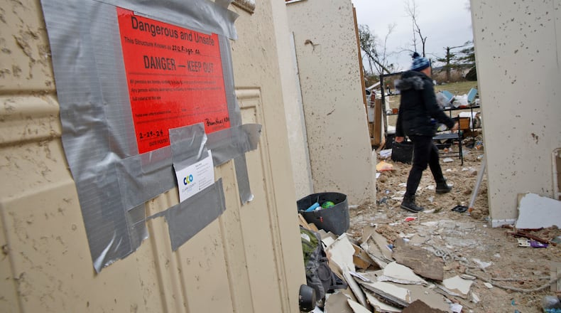 Emi Campbell and her family collect the belongings Friday, March 1, 2024 as they prepare to move out the their Ridge Road house that was destroyed in Wednesday's tornado. BILL LACKEY/STAFF