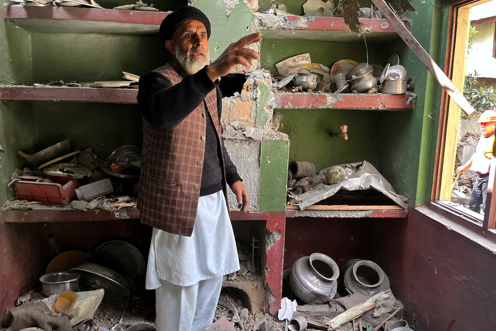 A Kashmiri villager examines damages to his house caused by overnight Indian shelling, in Shah Kot, in Neelum Vallery, a district of Pakistan's administered Kashmir, Saturday, May 10, 2025. (AP Photo/M.D. Mughal)