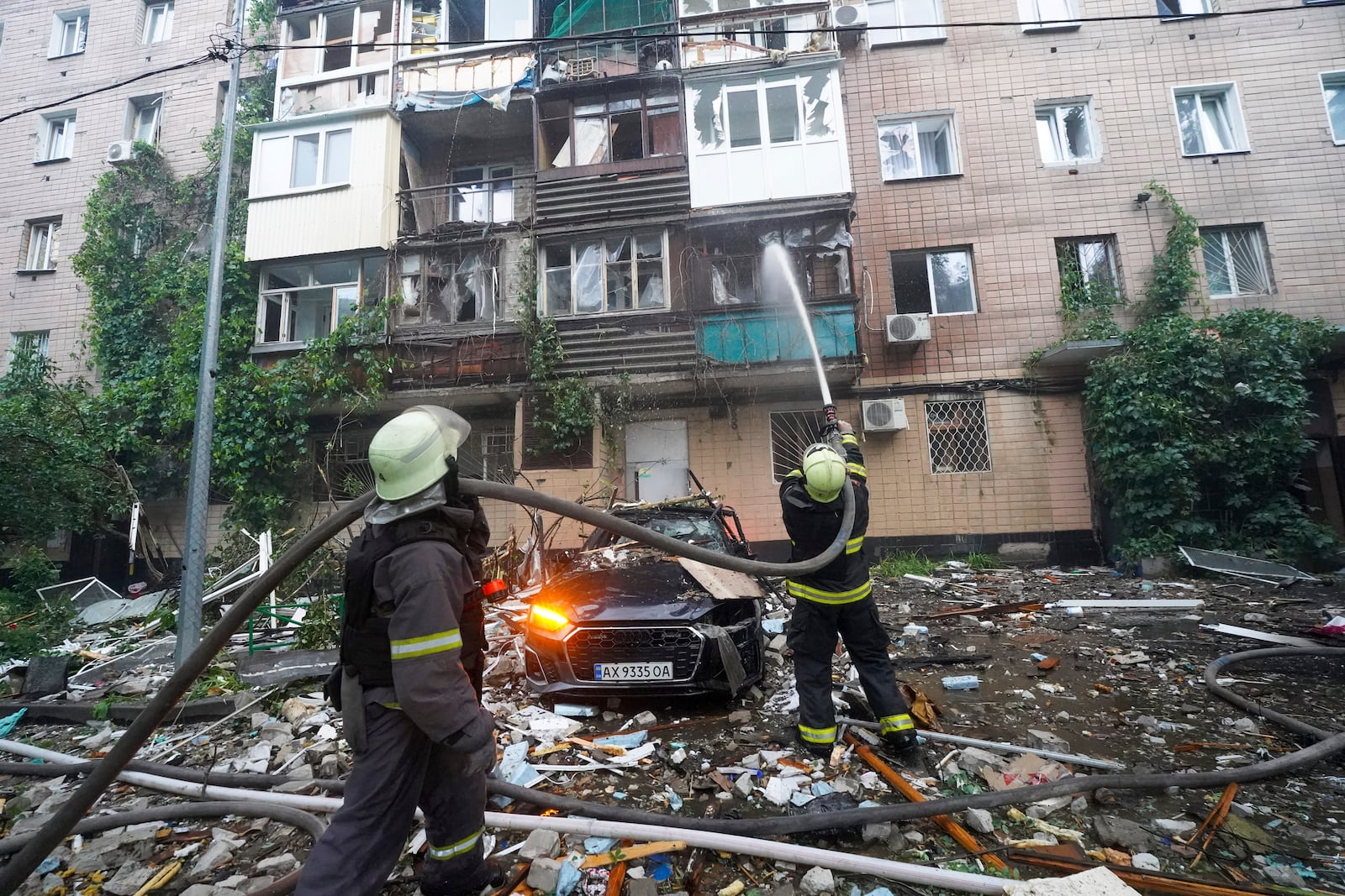 Firefighters tackle a blaze after a Russian attack that hit a residential building in Kharkiv, Ukraine, Saturday, June 7, 2025. (AP Photo/Andrii Marienko)