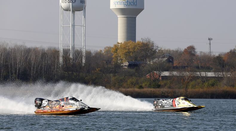 Formula 1 racing boats roar across the lake at the Clark County Fairgrounds Wednesday as Clark County conducts a feasibility study to see if power boat races can be brought to the area. Bill Lackey/Staff