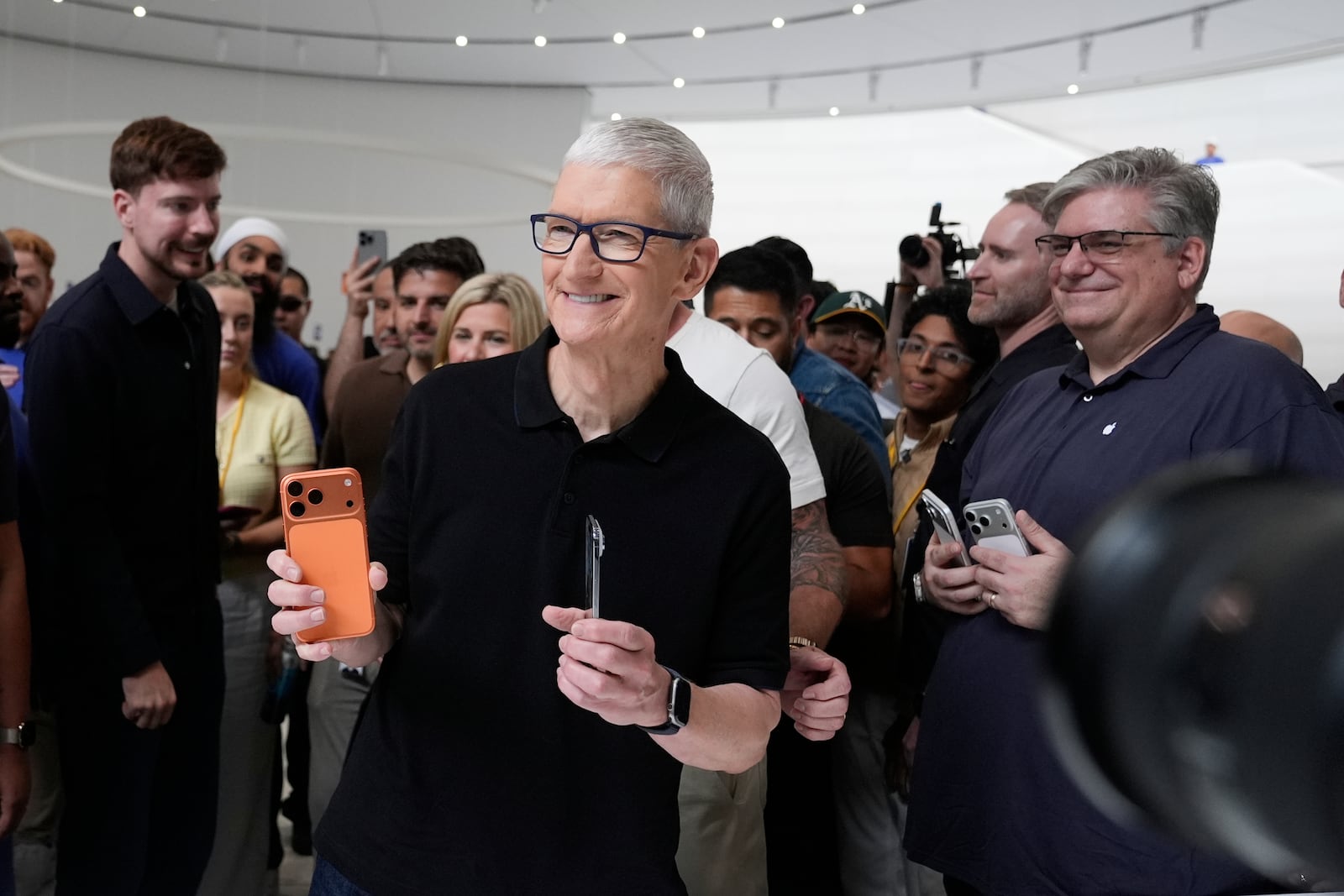 Apple CEO Tim Cook holds new iPhones during an announcement of new products at Apple Park on Tuesday, Sept. 9, 2025, in Cupertino, Calif. (AP Photo/Godofredo A. Vásquez)