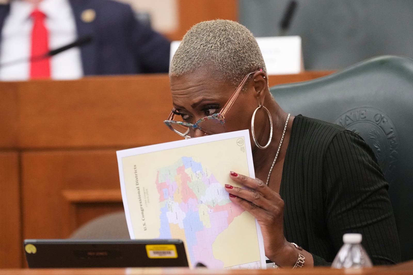 Texas state Rep. Jolanda "Jo" Jones looks through U.S. Congressional District maps during a redistricting hearing at the Texas Capitol, Thursday, July 24, 2025, in Austin, Texas. (AP Photo/Eric Gay)