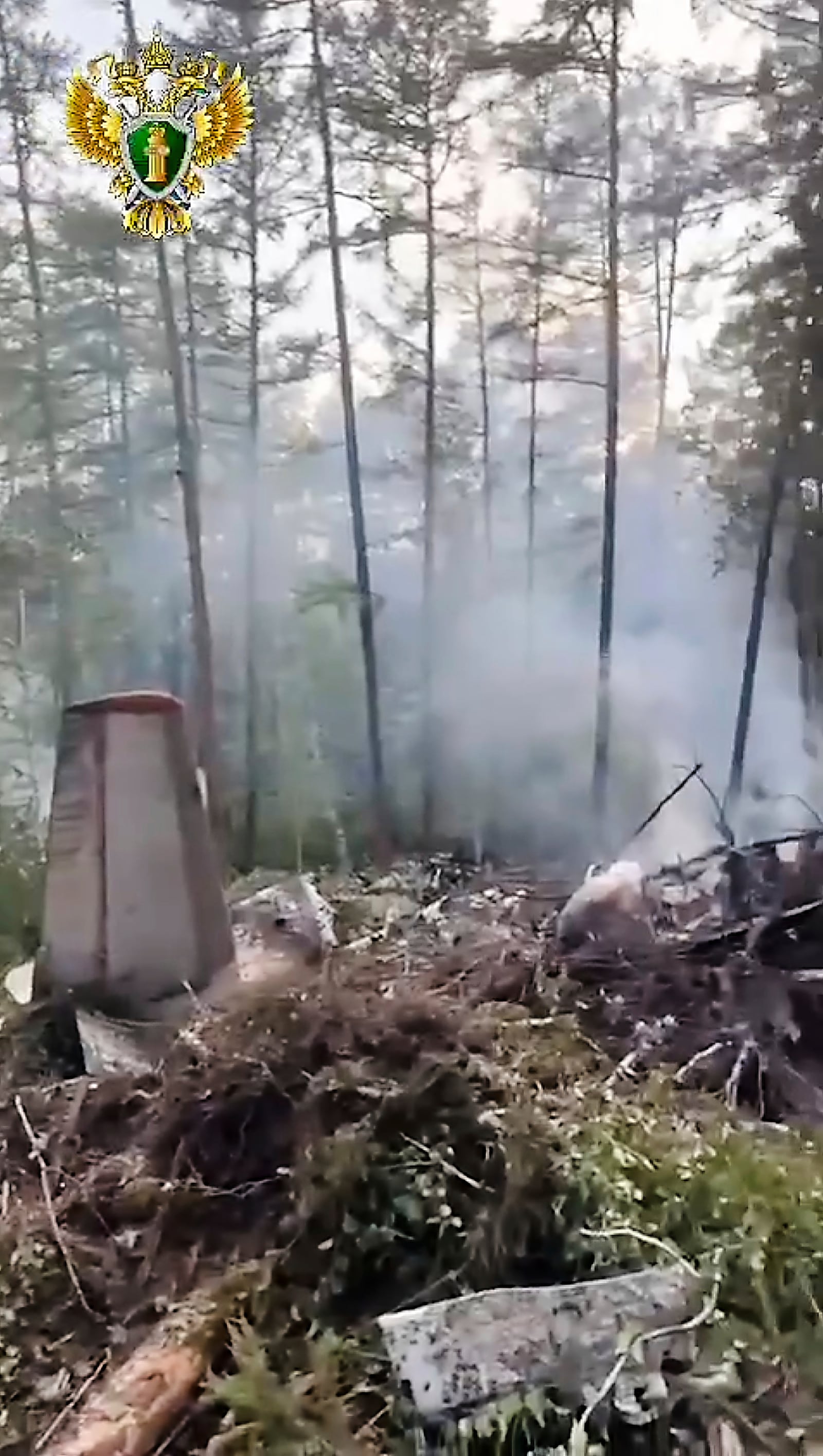In this photo taken from video released by Russian Far Eastern Transport Prosecutor's Office on Thursday, July 24, 2025, a view of the place of the crashed Russian An-24 passenger plane of the Siberia-based Angara Airlines while carrying 49 passengers in 15 kilometers (9 miles) south of Tynda, Far Eastern Amur region of Russia. (Russian Far Eastern Transport Prosecutor's Office via AP)