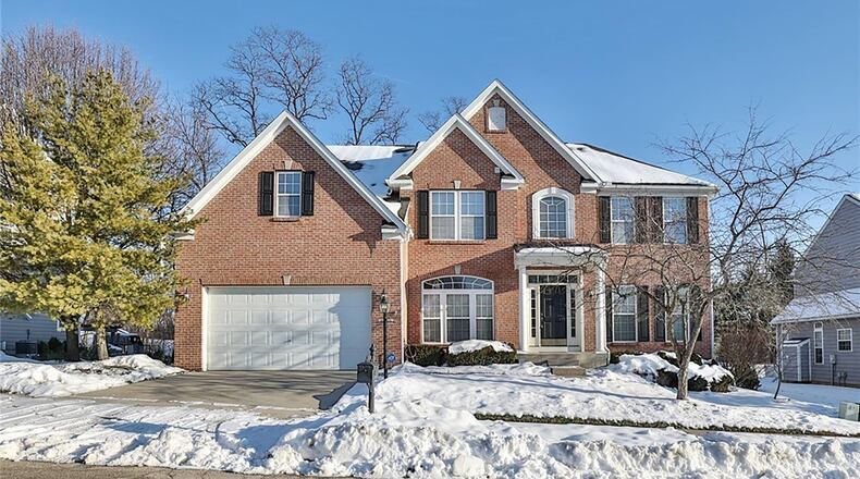 This traditional two story has a brick front and five bedrooms with three bathrooms up stairs and a half bathroom on the first level.