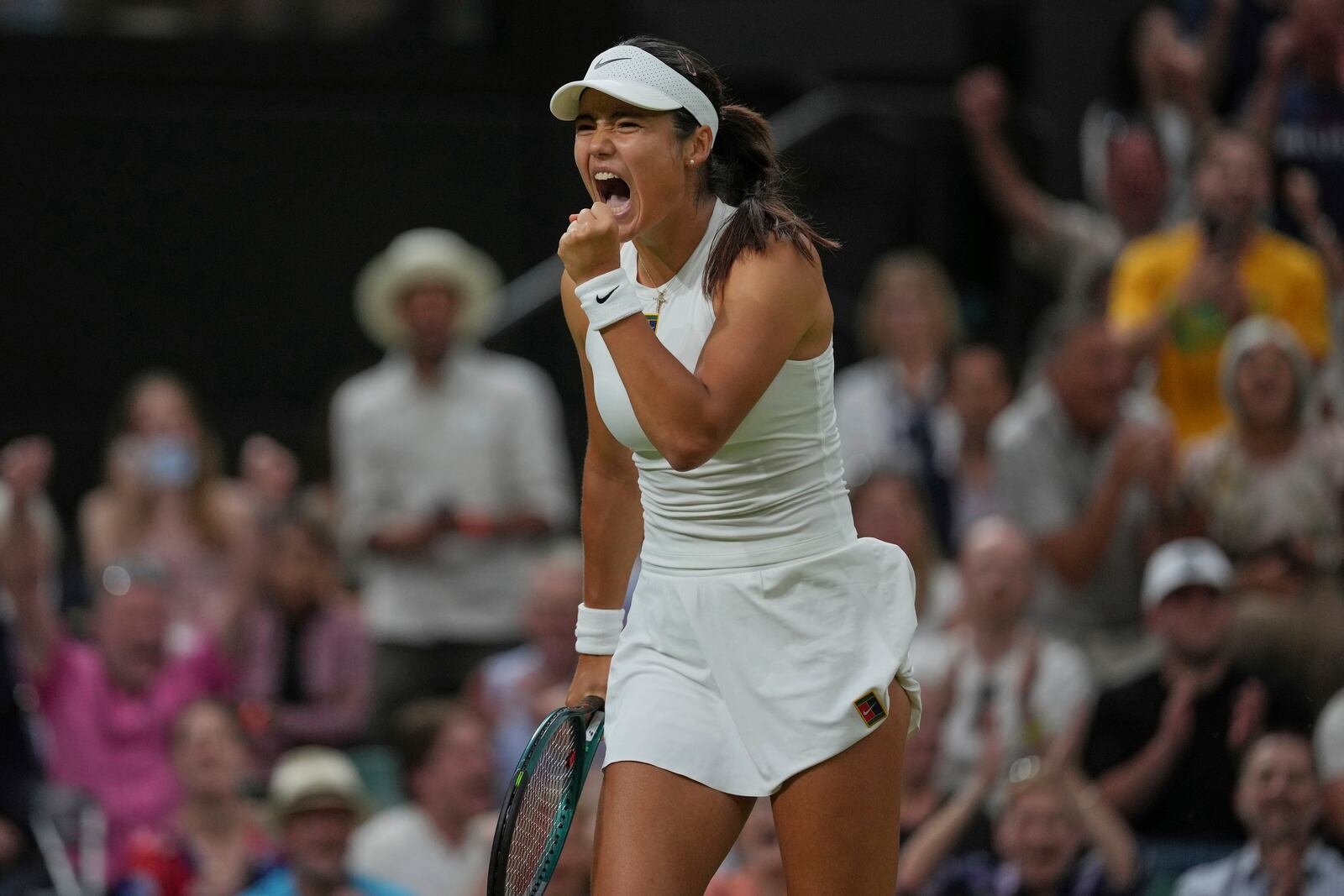 Emma Raducanu of Britain reacts after winning a point against Aryna Sabalenka of Belarus during a third round women's singles match at the Wimbledon Tennis Championships in London, Friday, July 4, 2025. (AP Photo/Kin Cheung)