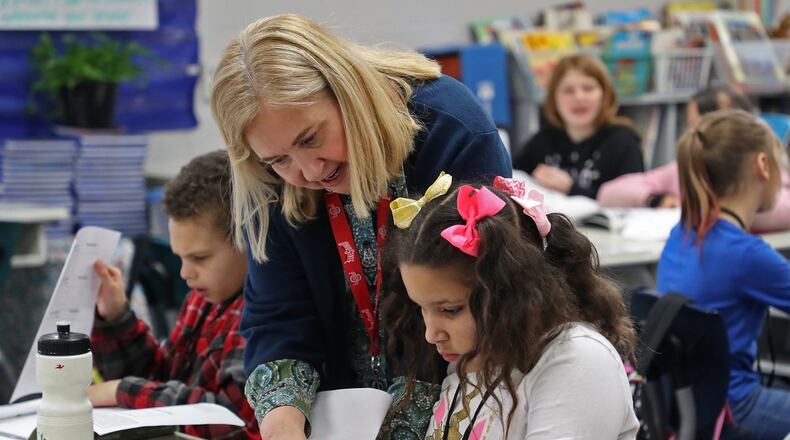 Lotus Smith, English and Science teacher at Lagonda Elementary School in the Springfield City School District, instructs a student during class time in 2020. BILL LACKEY/STAFF