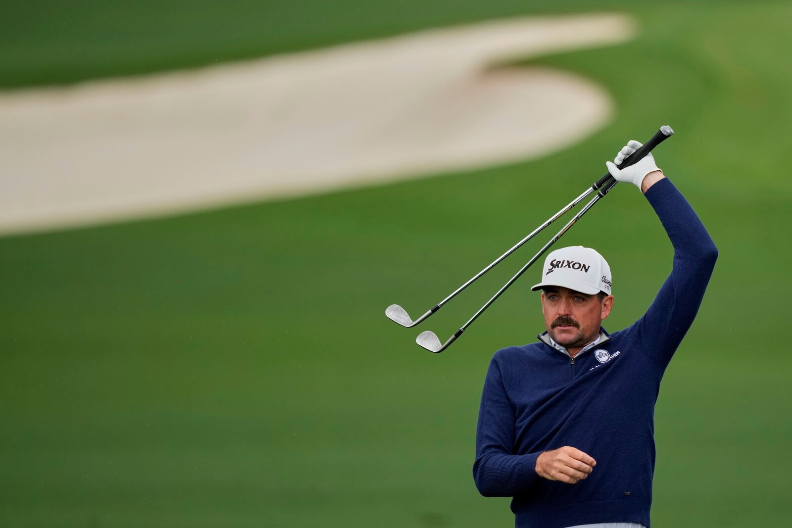 Keegan Bradley stretches on the driving range during a practice round at the Masters golf tournament, Monday, April 7, 2025, in Augusta, Ga. (AP Photo/Matt Slocum)