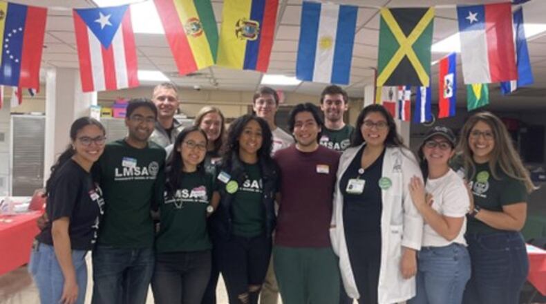 Wright State University and Boonshoft School of Medicine students are partnering to hold Latino Wellness Clinics geared toward people in the community who only or mostly speak Spanish, with the next one coming up on Dec. 9. Pictured in the first row, left to right, are Gisella Drouet, Ankur Parekh, Deborah Lee, Sade Fayiga, Ian Pabon Gonazalez, Dr. Ruth Claros, Catherine Hernandez Hogan, and Enedina Sepulveda Martinez. In the second row are Will Bohne, Sam Doehring, Steffen Fallini, and Kevin Williams. PROVIDED