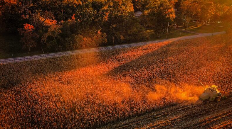 A farmer in Western Montgomery County harvest corn in the late day sun Tuesday Oct. 26, 2021. JIM NOELKER/STAFF