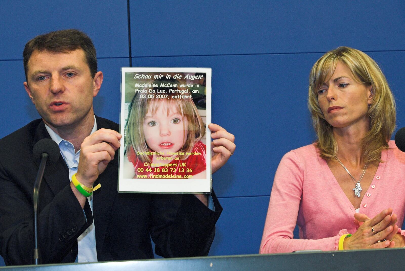 FILE - Gerry, left, and Kate McCann, parents of four-year old Madeleine McCann, present a picture of their daughter during a press conference in Berlin, Wednesday, June 6, 2007. (AP Photo/Sven Kaestner, File)