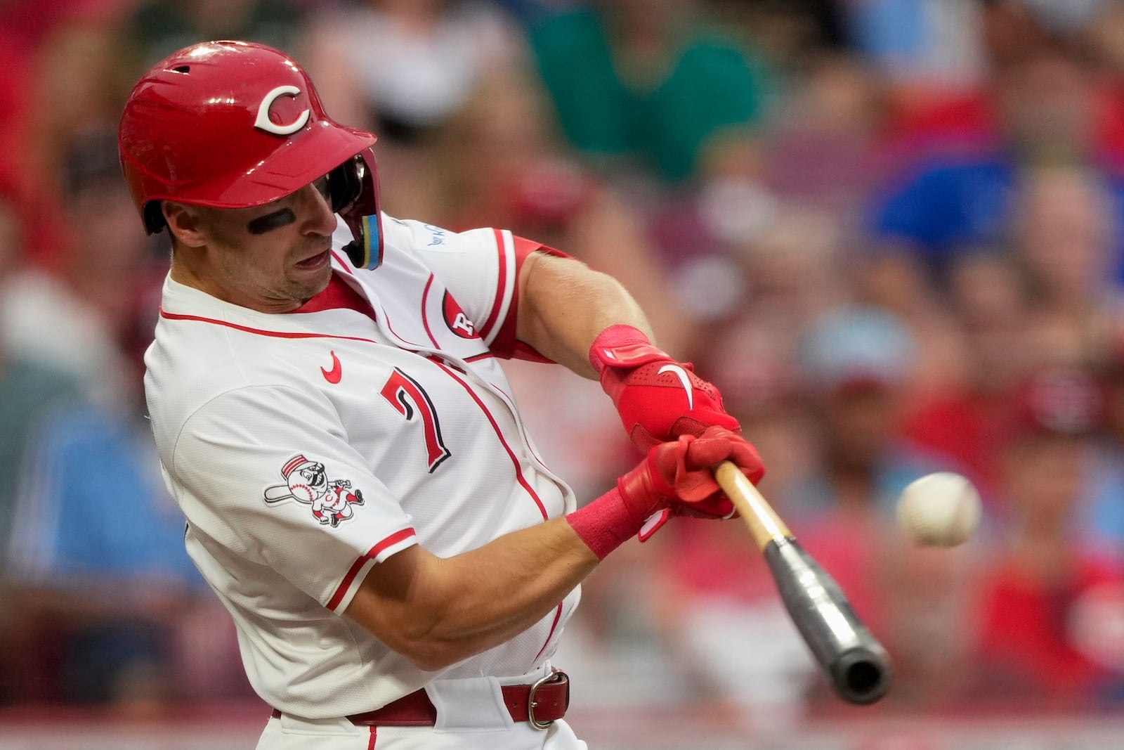 Cincinnati Reds' Spencer Steer hits a two-run double during the third inning of a baseball game against the Philadelphia Phillies Tuesday, Aug. 12, 2025, in Cincinnati. (AP Photo/Carolyn Kaster)