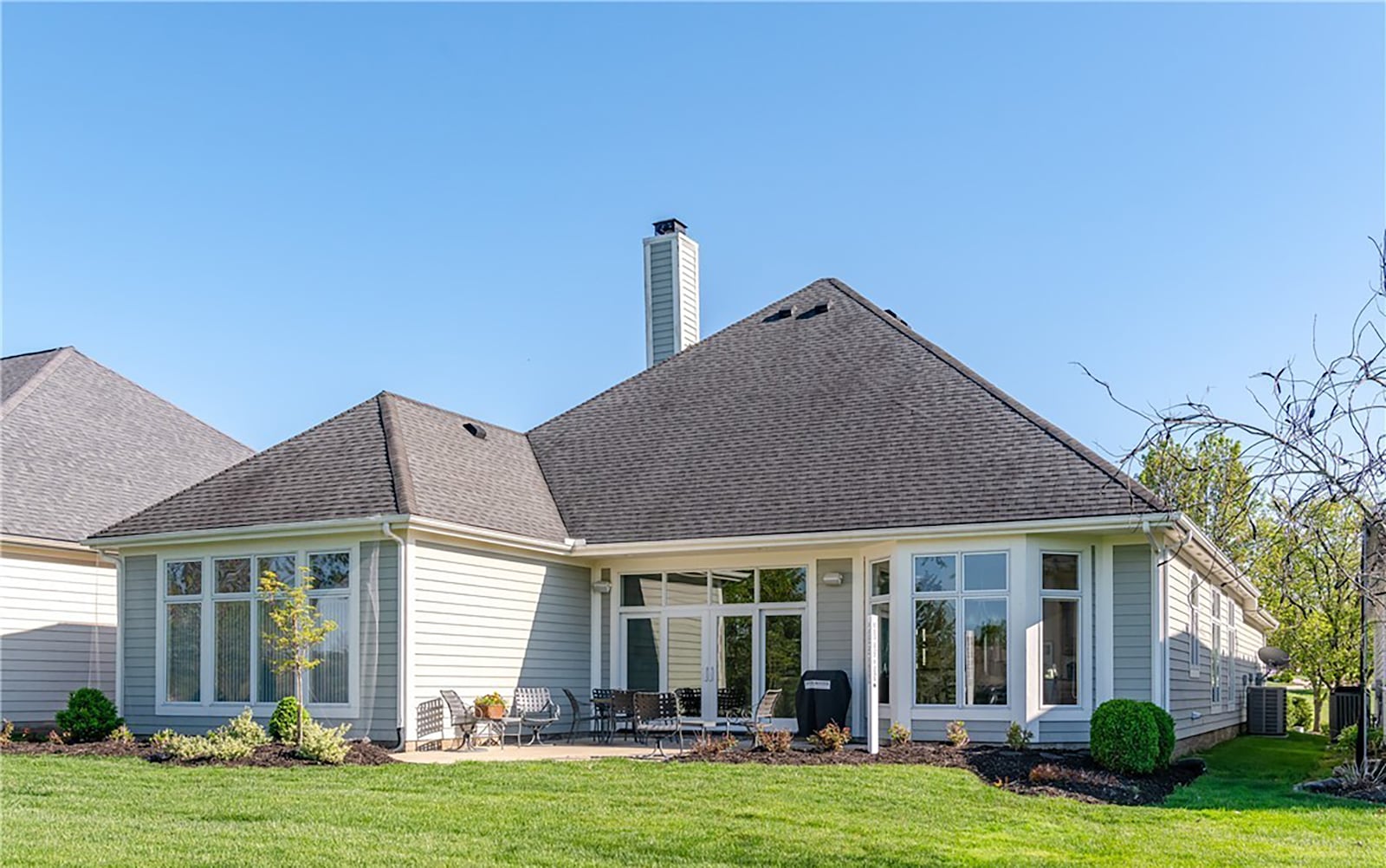 The rear of the home has a concrete patio that overlooks the golf course and lake beyond and a natural gas grill that conveys with the sale.