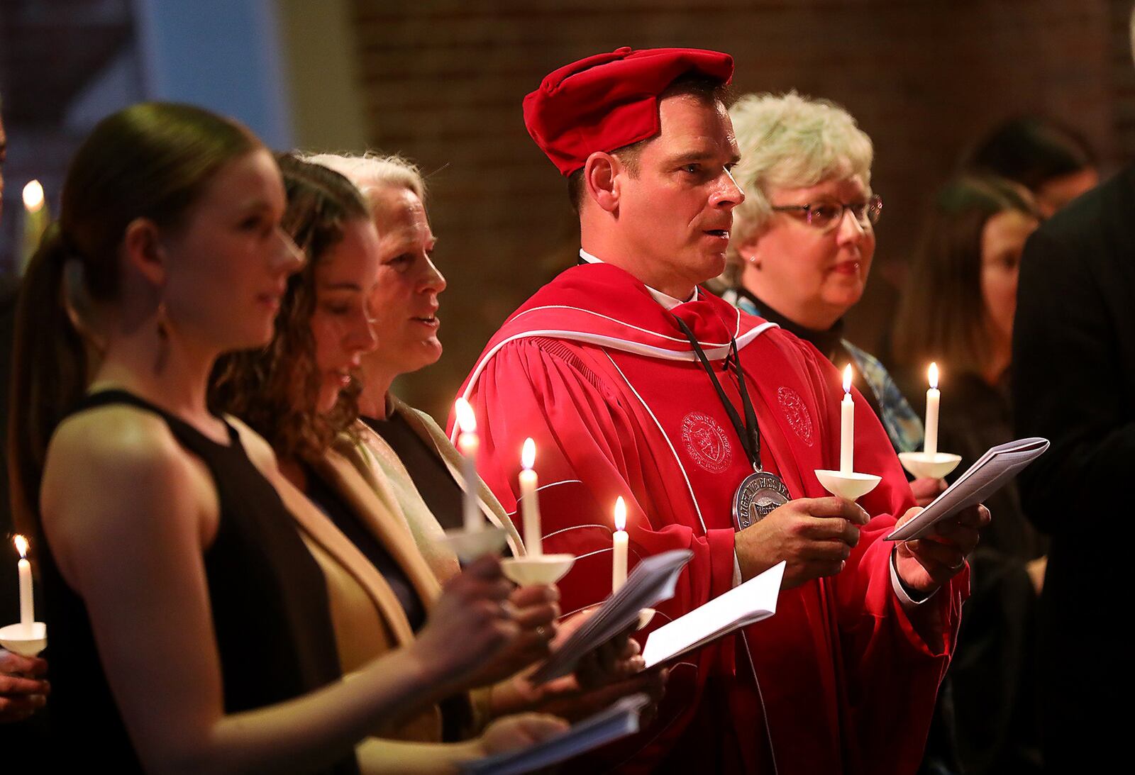 Dr. Michael Frandsen and his family sing the Wittenberg University Alma Mater after he was installed as the 15th president of the university during a ceremony in Weaver Chapel. Bill Lackey/Staff
