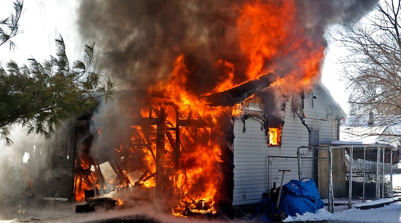The Springfield Fire Rescue Division battled a house fire at a residence in the 900 block of Emery Street Monday, Feb. 19, 2024. The fire appeared to start in an attached garages and quickly spread to the two story residence. Fire crews arrived to find flames and smoke billowing from the garage and rear of the house. Two residents were home at the time of the fire and were uninjured. The cause of the fire is under investigation. BILL LACKEY/STAFF