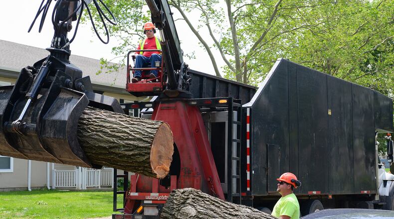 Contractors use heavy equipment to remove larges logs during the recovery operations at Wright-Patterson AFB. Volunteers from around Wright-Patterson AFB worked alongside base emergency responders and housing residents to ensure everyone’s safety and begin the cleanup process. (U.S. Air Force photo by R.J. Oriez)