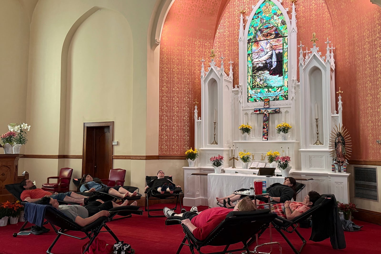 Congregants of St. Paul’s-San Pablo Lutheran Church receive acupuncture treatments in the sanctuary after worship during a wellness program the church started as part of its migrant ministry, in Minneapolis, Sunday, April 27, 2025. (AP Photo/Giovanna Dell’Orto)