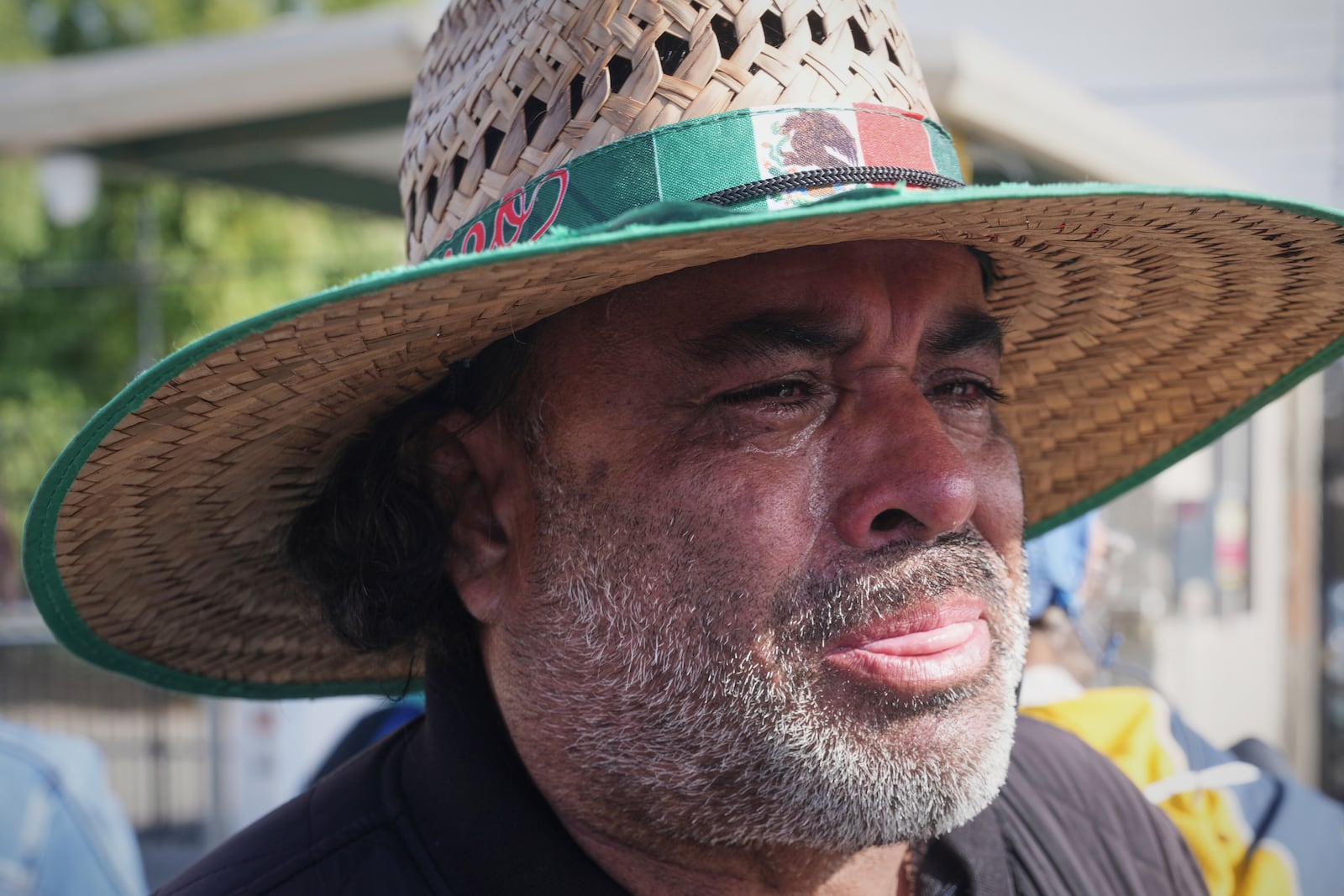 Juan Duran cries outside of Glass House Farms, where a relative was injured during a previous day immigration raid, on Friday, July 11, 2025, in Camarillo, Calif. (AP Photo/Damian Dovarganes)