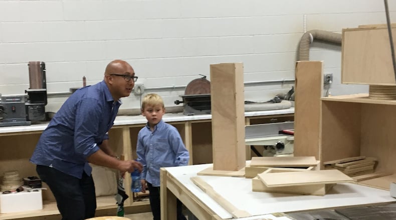 Stephen Mertens and son Hudson explore the wood shop on a tour during Sunday s open house at The Springfield Center for Innovation: The Dome. Photo by Brett Turner