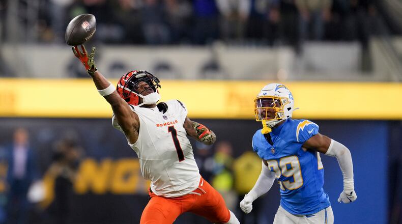Cincinnati Bengals wide receiver Ja'Marr Chase (1) reaches but cannot make a catch in front of Los Angeles Chargers cornerback Tarheeb Still (29) during the second half of an NFL football game Sunday, Nov. 17, 2024, in Inglewood, Calif. (AP Photo/Eric Thayer)