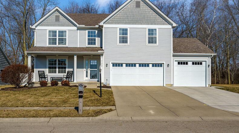 The front of the home has a newer third-car garage, concrete driveway and covered front porch with pillars. CONTRIBUTED PHOTOS