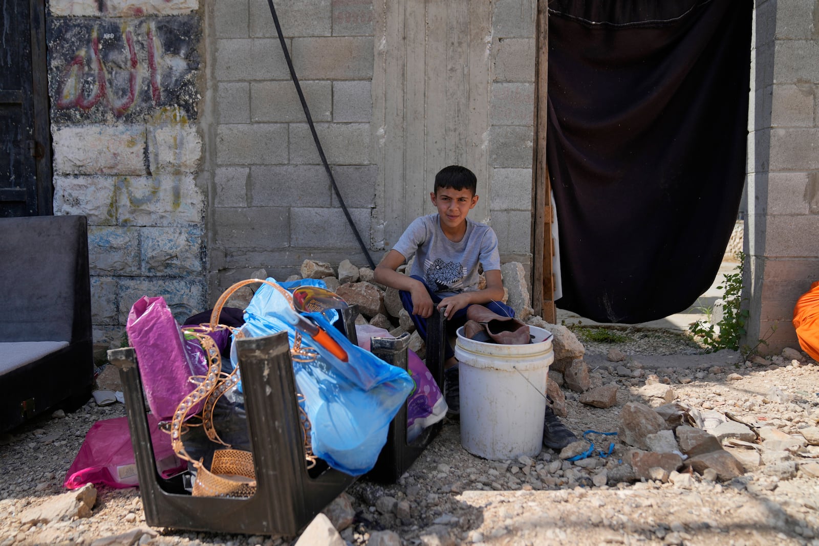 Residents of the now evacuated refugee camp of Tulkarem return to collect belongings before the destruction of their homes as Israeli forces prepare to carry out the demolition of 116 homes across the two refugee camps of the Israeli occupied West Bank city of Tulkarem, Friday, May 2, 2025. (AP Photo/Nasser Nasser)