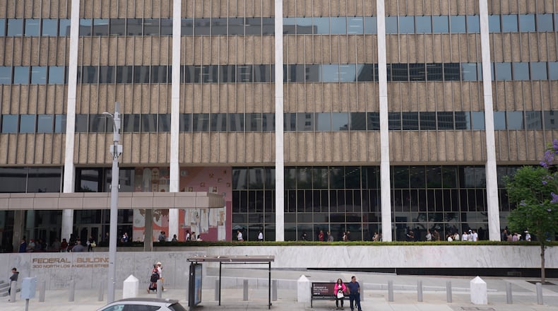 FILE People line up outside the Los Angeles Federal Building in Los Angeles, June 25, 2025. (AP Photo/Damian Dovarganes, File)