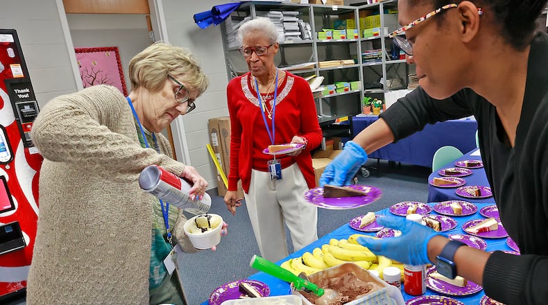 The staff at Fulton Elementary, from left, Sharon Bohn, Peggy Jones and April Turner, celebrate Teacher Appreciation Week on Wednesday, May 10, 2023, with a sundae and cheesecake bar on their lunch break. BILL LACKEY/STAFF