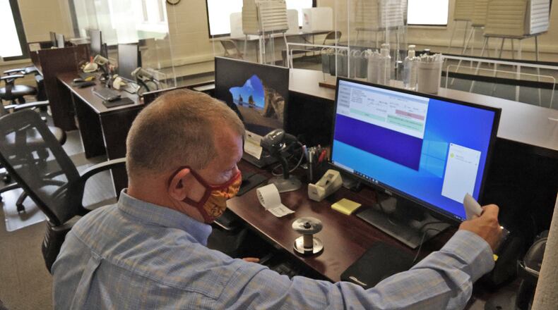 Jason Baker, director of the Clark County Board of Elections, tests all the equipment at the Board of Elections for the start of early voting for the May 4th election. BILL LACKEY/STAFF