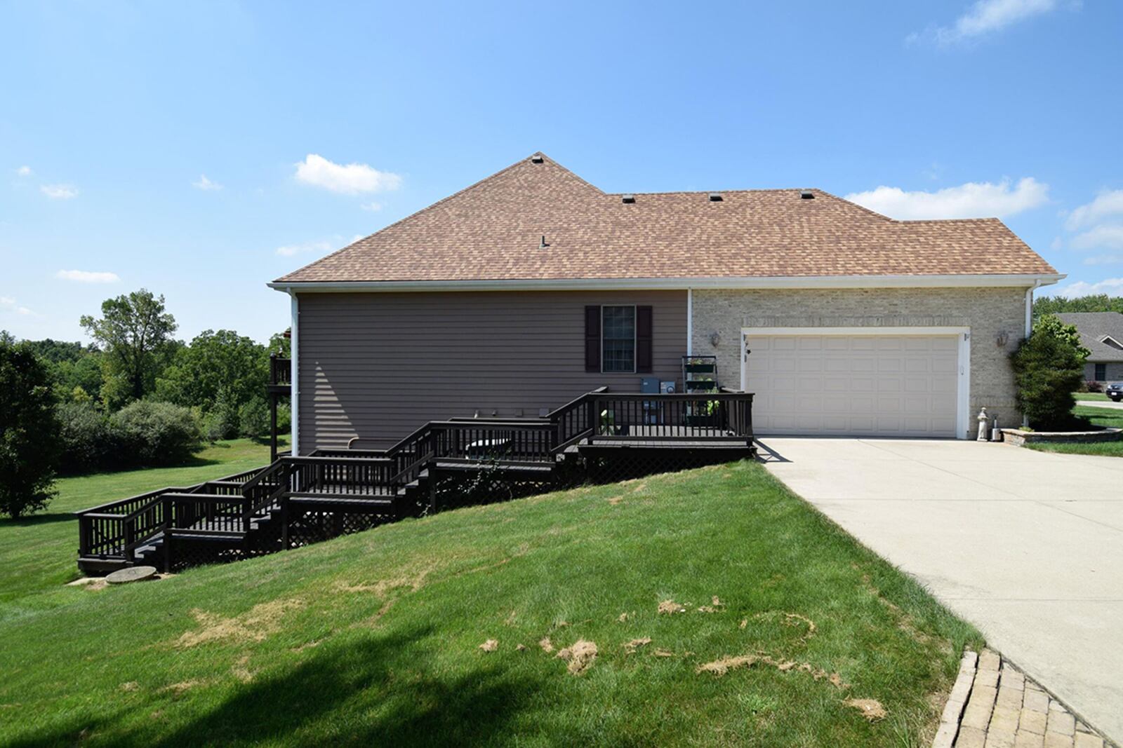 A long, concrete driveway leads to both a detached, 1-car garage and an attached, 2-car garage. CONTRIBUTED PHOTO