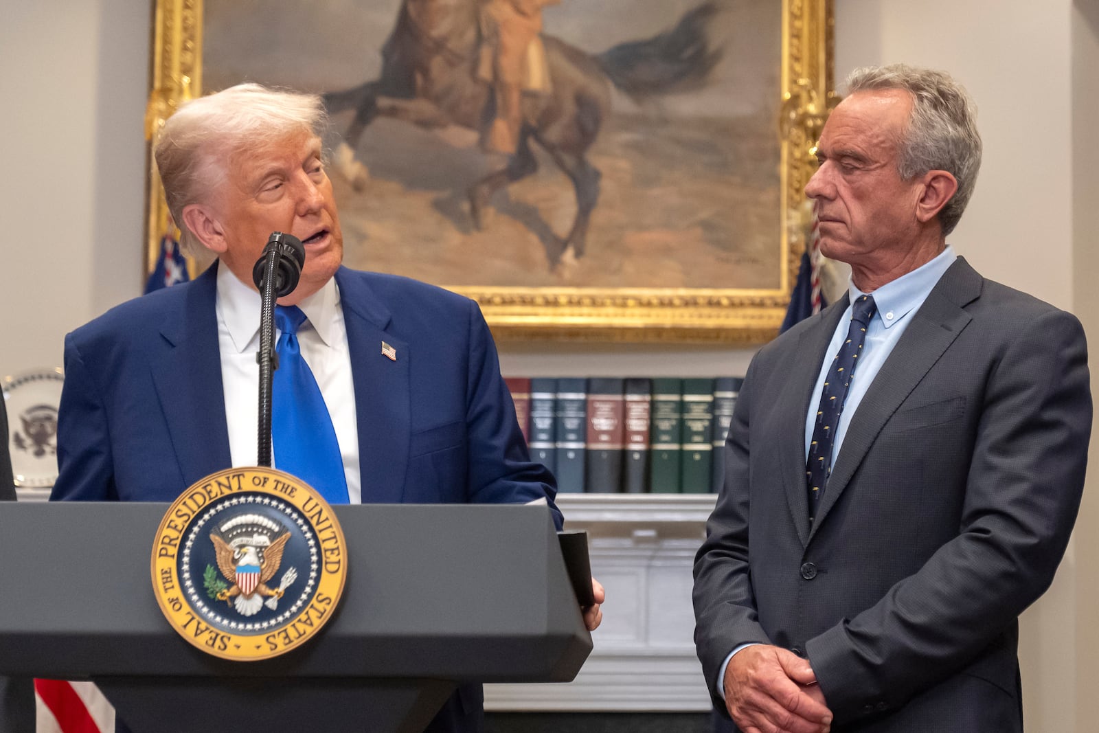 FILE - President Donald Trump, from left, speaks as Health and Human Services Secretary Robert F. Kennedy Jr., during an event in the Roosevelt Room at the White House, May 12, 2025, in Washington. (AP Photo/Mark Schiefelbein, File)\\\