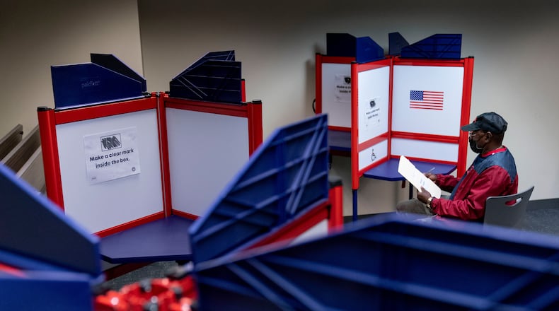 FILE - Cornelius Whiting fills out his ballot at an early voting location in Alexandria, Va., Sept. 26, 2022. (AP Photo/Andrew Harnik, File)