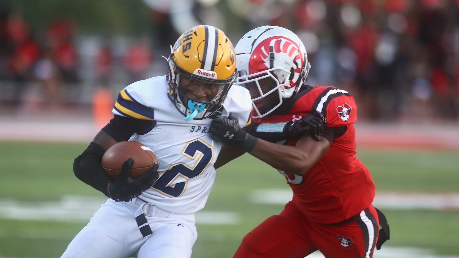 Springfield's Sherrod Lay Jr. runs the ball against Trotwood-Madison's Mike Keith on Friday, Sept. 5, 2025, at Trotwood. David Jablonski/Staff