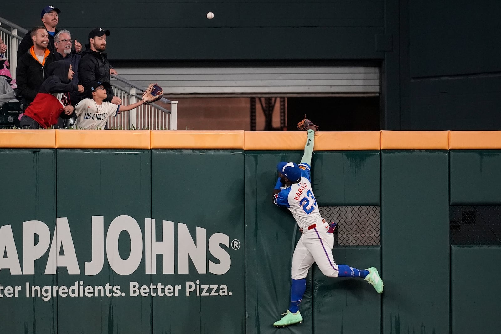 Atlanta Braves outfielder Michael Harris II (23) tries to catch the ball of the bat of Los Angeles Dodgers two-way player Shohei Ohtani (17) in the third inning of a baseball game, Saturday, May 3, 2025, in Atlanta. (AP Photo/Mike Stewart)