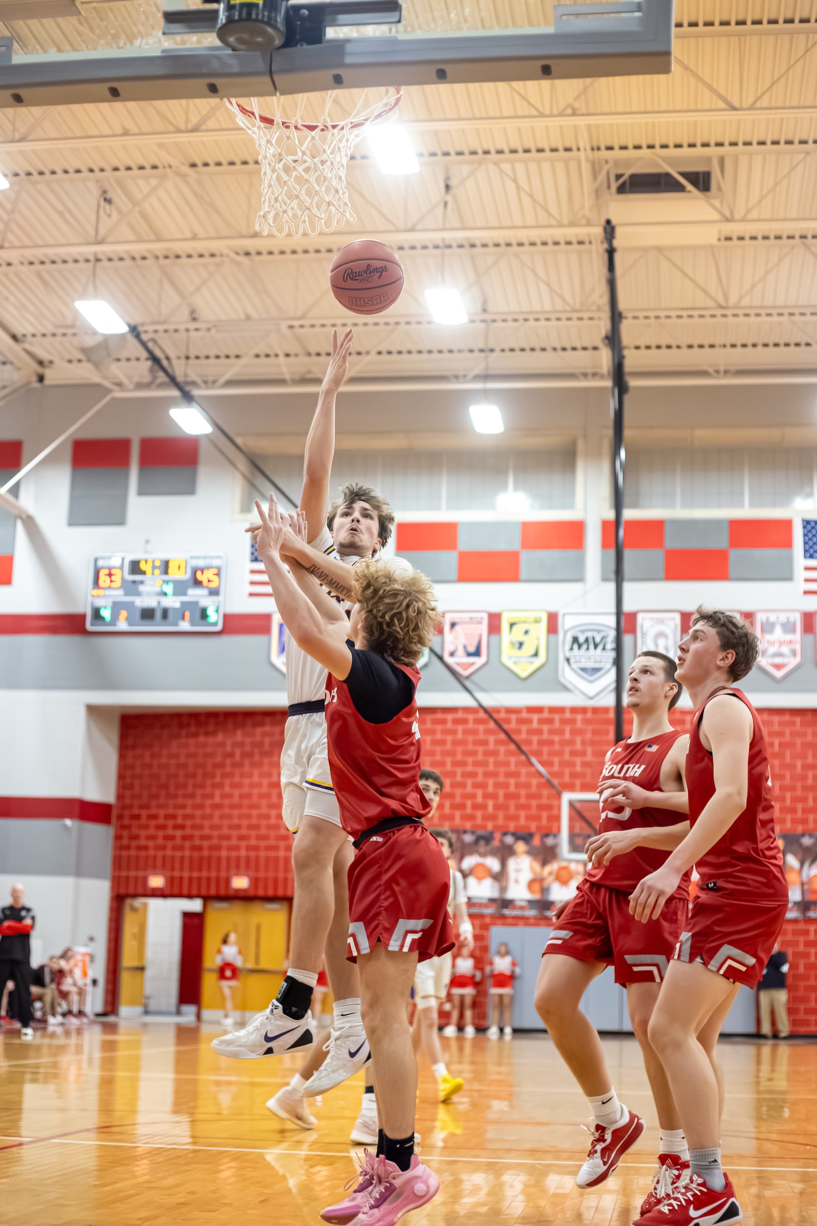 Emmanuel Christian senior Nate Hudson shoots the ball over Twin Valley South senior Aidan White during their Division VI district semifinal game on Monday, March 3, 2026 at Troy High School. The Lions won 73-51. MICHAEL COOPER / STAFF