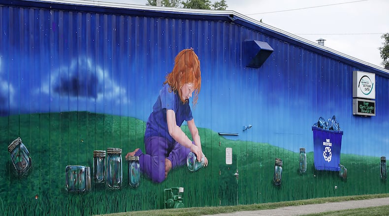 Artist Mariah Kaminsky painted the mural on the Clark County Solid Waste District's Recycling Center, where residents can recycle old Christmas lights at the specialty recycling center. BILL LACKEY/STAFF