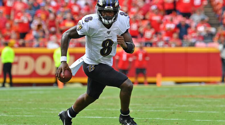 KANSAS CITY, MO - SEPTEMBER 22: Quarterback Lamar Jackson #8 of the Baltimore Ravens scrambles to the outside against the Kansas City Chiefs during the second half at Arrowhead Stadium on September 22, 2019 in Kansas City, Missouri. (Photo by Peter Aiken/Getty Images)