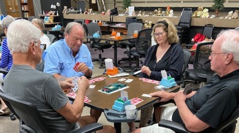 Members of the Miami Valley Bridge Association concentrate on their cards but take breaks to chat and enjoy snacks between hands. CONTRIBUTED
