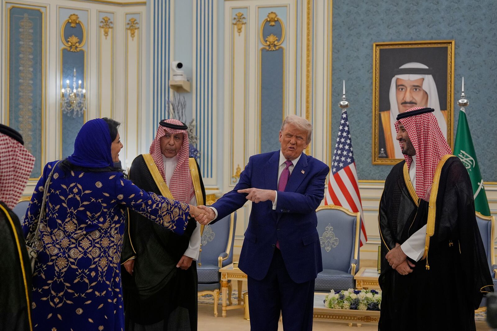 President Donald Trump gestures to Saudi Crown Prince Mohammed bin Salman as he greets Reema bint Bandar Al Saud, Saudi ambassador to the United States, at the Royal Palace in Riyadh, Saudi Arabia, Tuesday, May 13, 2025 (AP Photo/Alex Brandon)