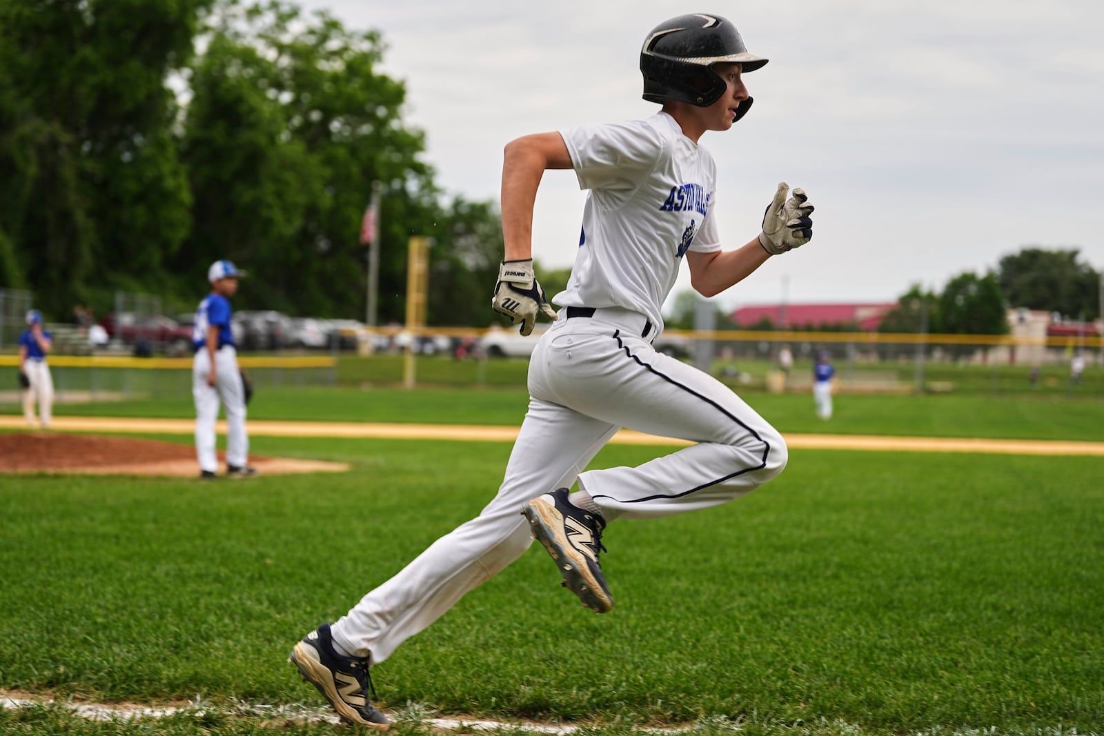 Jax Casamento, 15, runs to first base during his youth baseball game in Aston, Pa., Tuesday, May 27, 2025. (AP Photo/Matt Rourke)