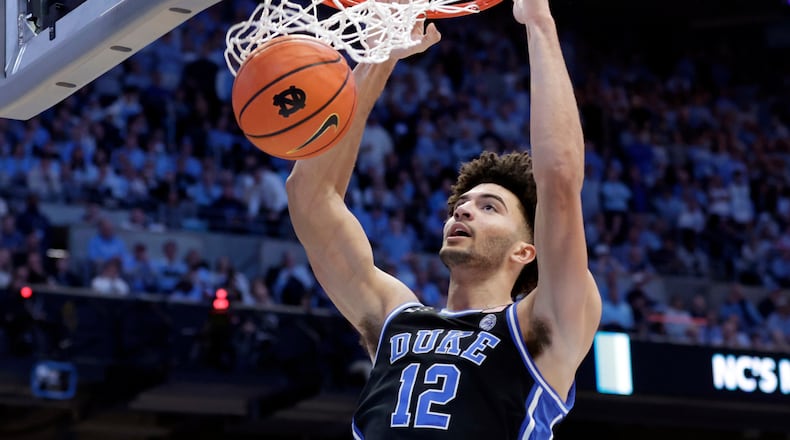 FILE - Duke forward Cameron Boozer dunks during the second half in an NCAA college basketball game against North Carolina, Saturday, Feb. 7, 2026, in Chapel Hill, N.C. (AP Photo/Chris Seward, File)