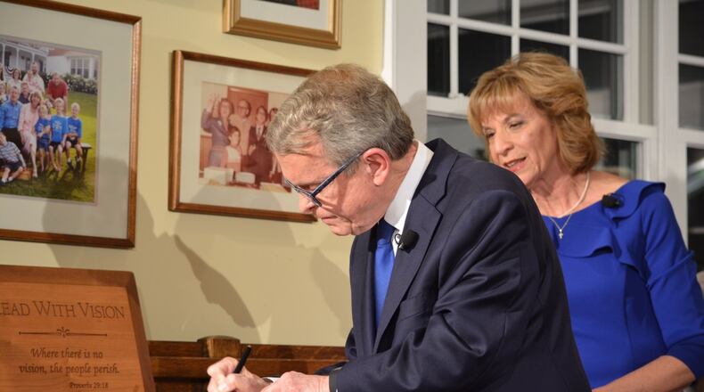 New Ohio Governor signs six executive orders immediately after taking office Monday at his home in Cedarville. Photo by Jim Otte, Newscenter 7