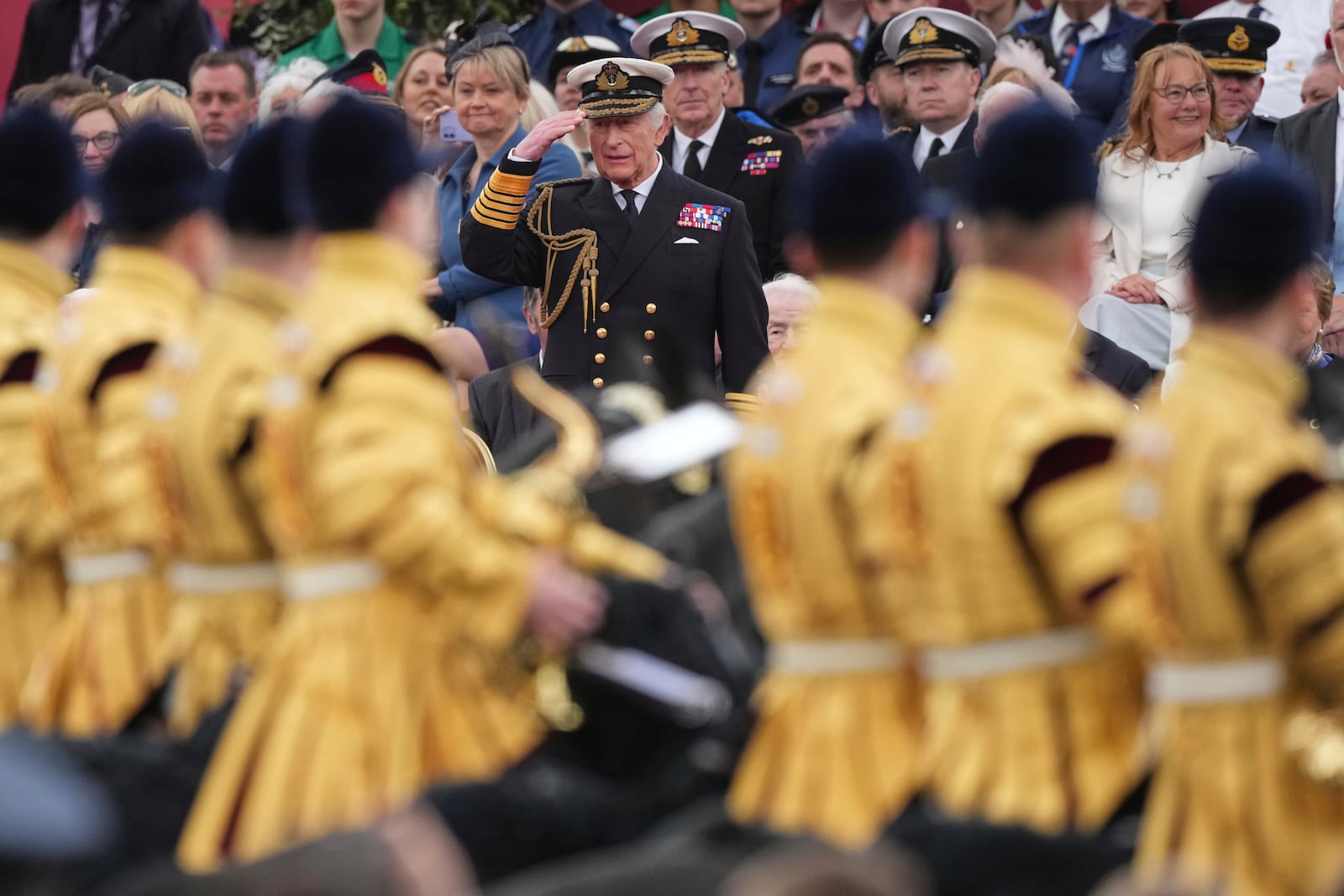 Britain's King Charles III salutes as he watches the V-E Day 80th anniversary parade in London, Monday, May 5, 2025. (AP Photo/Frank Augstein)