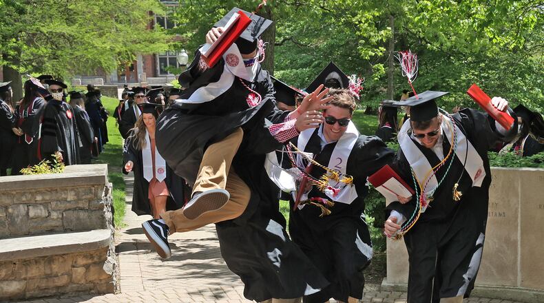 Wittenberg University graduates perform the traditional "Stomp The Seal" Saturday following the university's 171 Commencement Ceremony. To provide space for social distancing, the commencement was divided into two ceremonies and held at Edwards-Maurer Stadium instead of the traditional Commencement Hollow. BILL LACKEY/STAFF