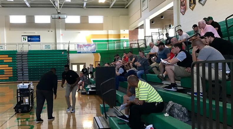 Ohio State defensive line coach Larry Johnson (left) addresses area high school football coaches in a clinic at Northmont High School.