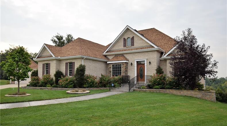 The front of the custom, brick ranch features a cobbled brick pathway to the front entry with stone wrapped extended patio. The 4-bedroom home offers about 3,480 sq. ft. of living space with a full, finished, walk-out lower level. CONTRIBUTED PHOTO