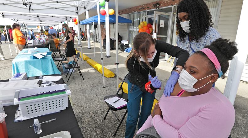 Dameka Cunigan gets the COVID vaccine shot during the second annual Community Health Fair at FamilyNeeds, Inc. Thursday. Health care organization and doctors were on hand to do health check and to educate residents about healthy living. BILL LACKEY/STAFF