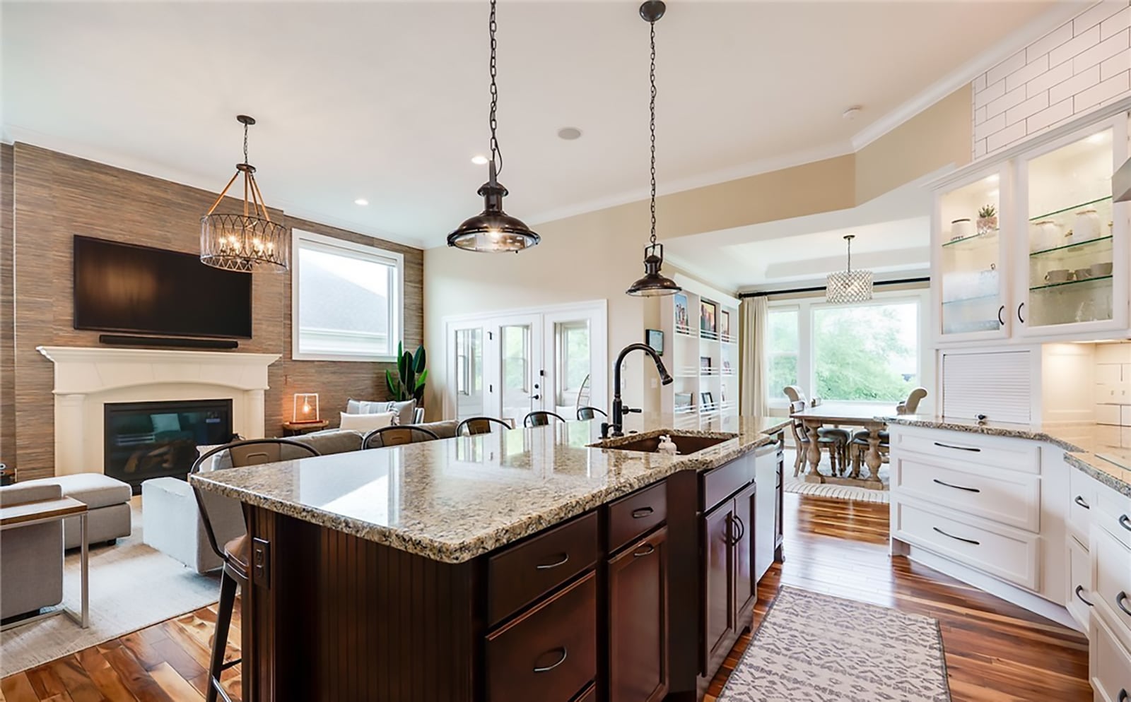 The open concept kitchen, living room and dining room has hardwood floors throughout. The living room has a gas fireplace and the kitchen features top of the line Bosch appliances. The dining room has a built in bookcase along one wall. CONTRIBUTED